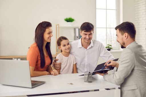 Happy Family Couple Signing The Contract With Agent